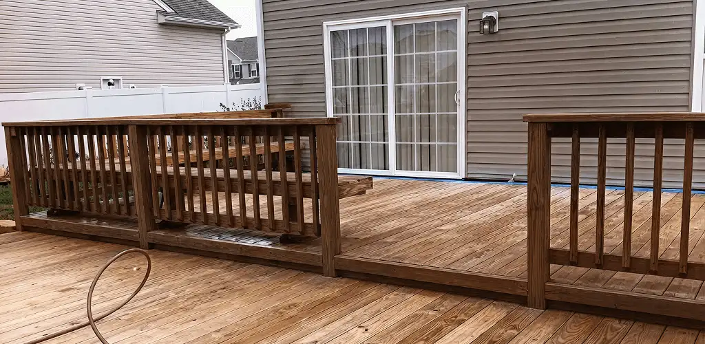 Deck sealing service protecting a backyard wood deck and railings in Lakewood, CO