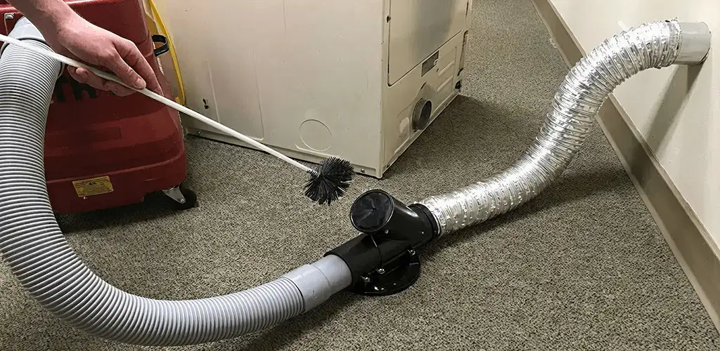 Dryer vent cleaning service removing lint from a dryer duct connection in Lakewood, CO