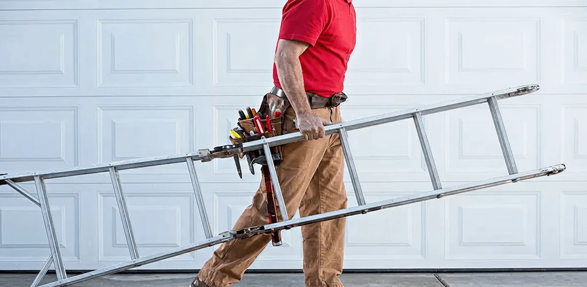 Garage door repair technician arriving with tools and ladder in Lakewood, CO