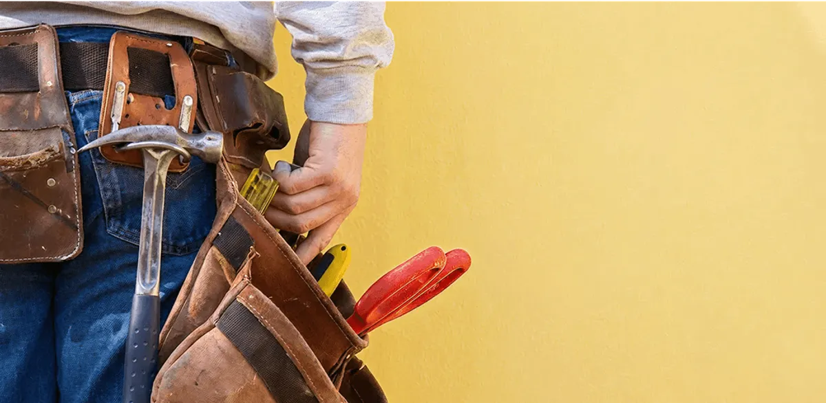 Handyman with tool belt ready for home repairs and maintenance in Lakewood, CO