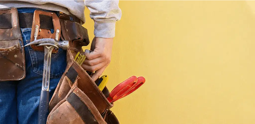 Handyman with tool belt ready for home repairs and maintenance in Lakewood, CO