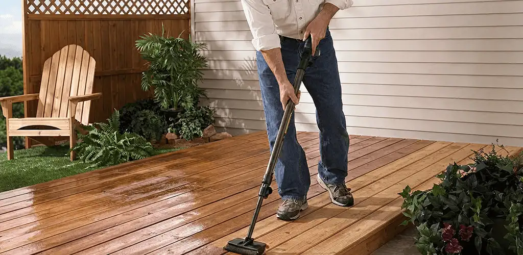 Deck staining service applying stain to a backyard wood deck in Lakewood, CO